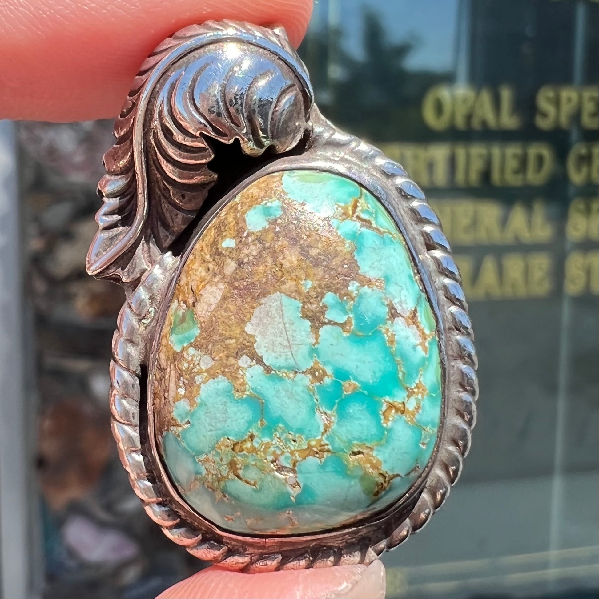 A handmade silver Navajo style pendant set with a turquoise stone from Kingman, Arizona.