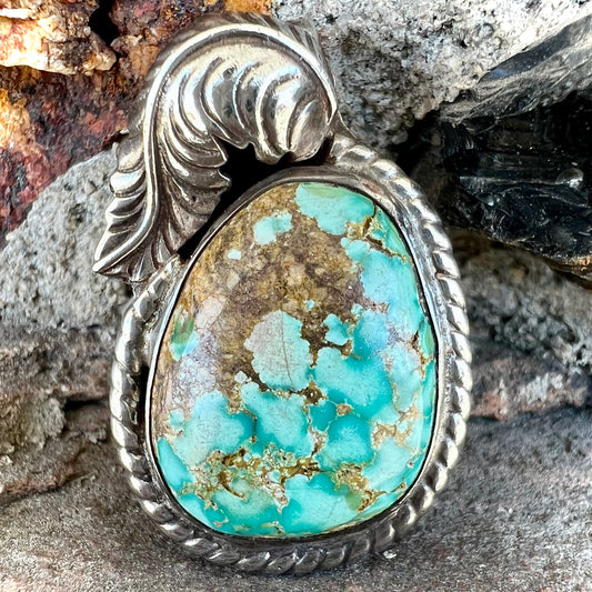 A handmade silver Navajo style pendant set with a turquoise stone from Kingman, Arizona.