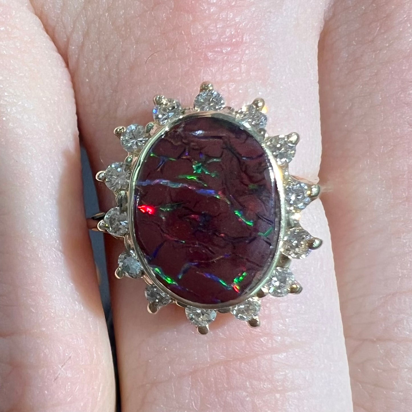 A ladies' diamond halo and Koroit boulder opal engagement ring.