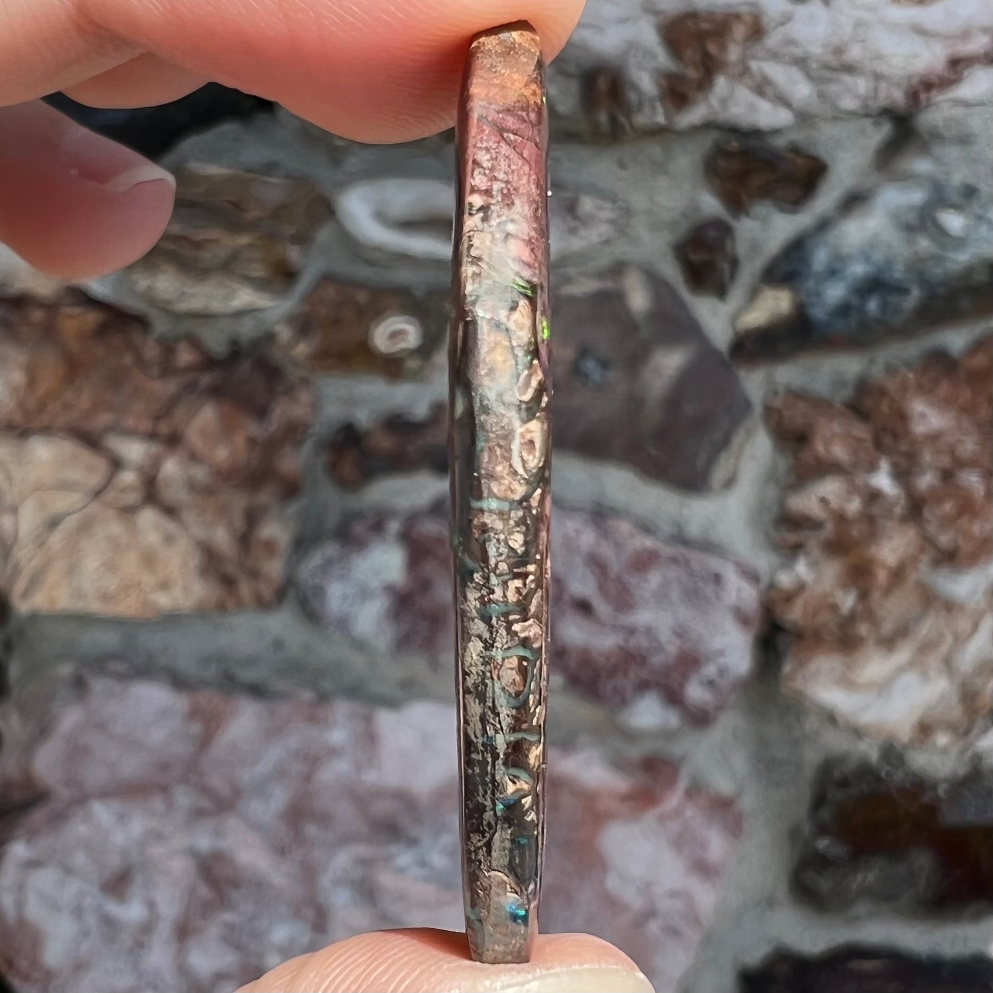 A loose, patterned boulder opal stone from the Koroit Mining District in Queensland, Australia.
