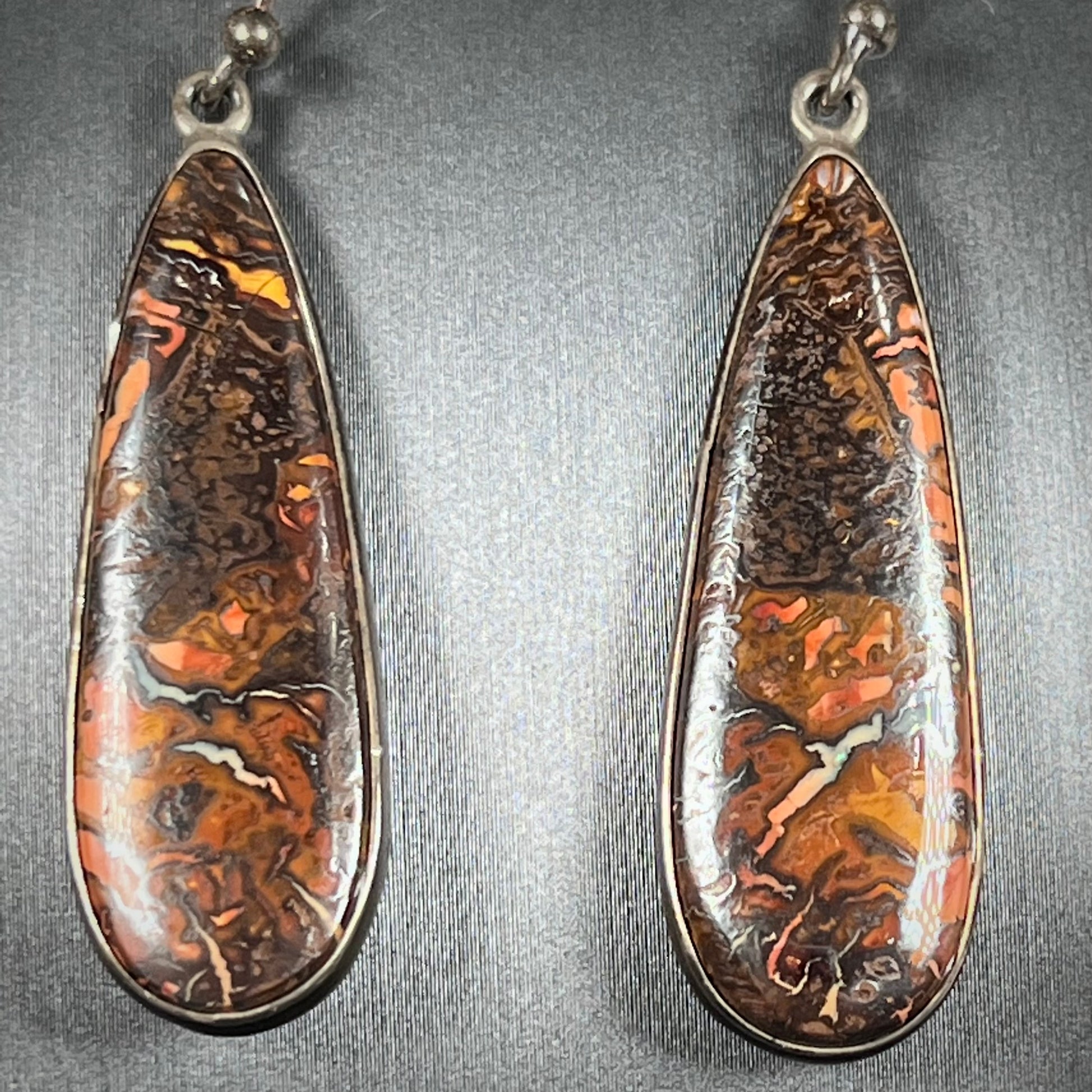 A pair of sterling silver boulder opal drop dangle earrings.