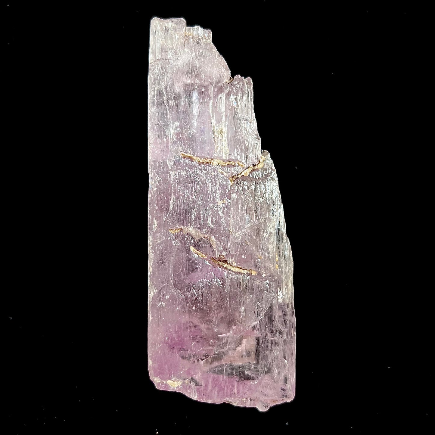 A five inch long pink kunzite crystal.  The crystal is purple when viewed down the ends.