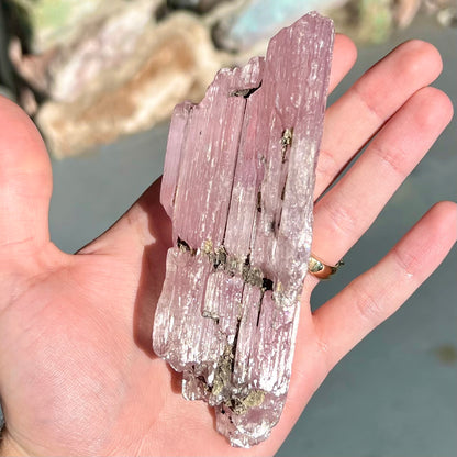 A large, pink kunzite crystal specimen.