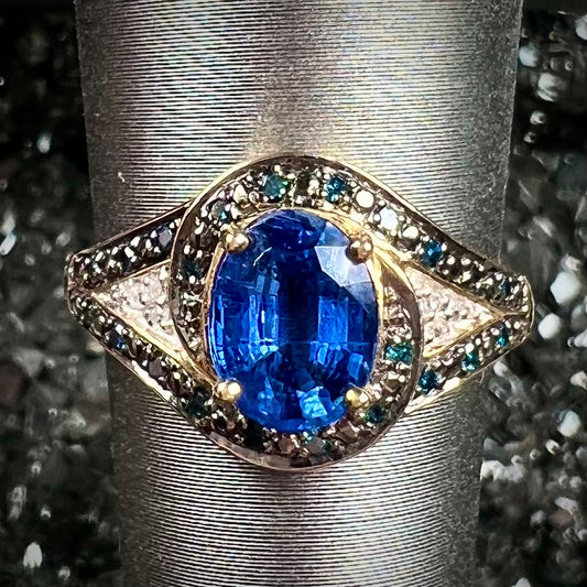 A ladies' oval cut blue kyanite twist ring pave set with blue and white diamond accents.