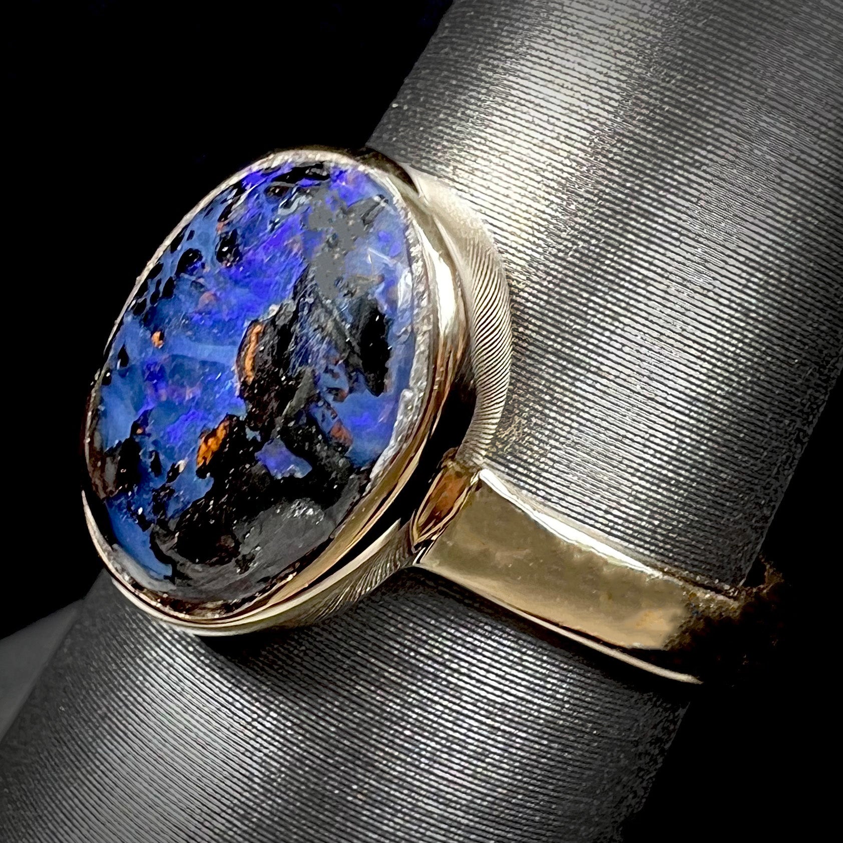 A handmade ladies' yellow gold boulder opal ring.  The opal is a natural purple Yowah nut boulder opal.