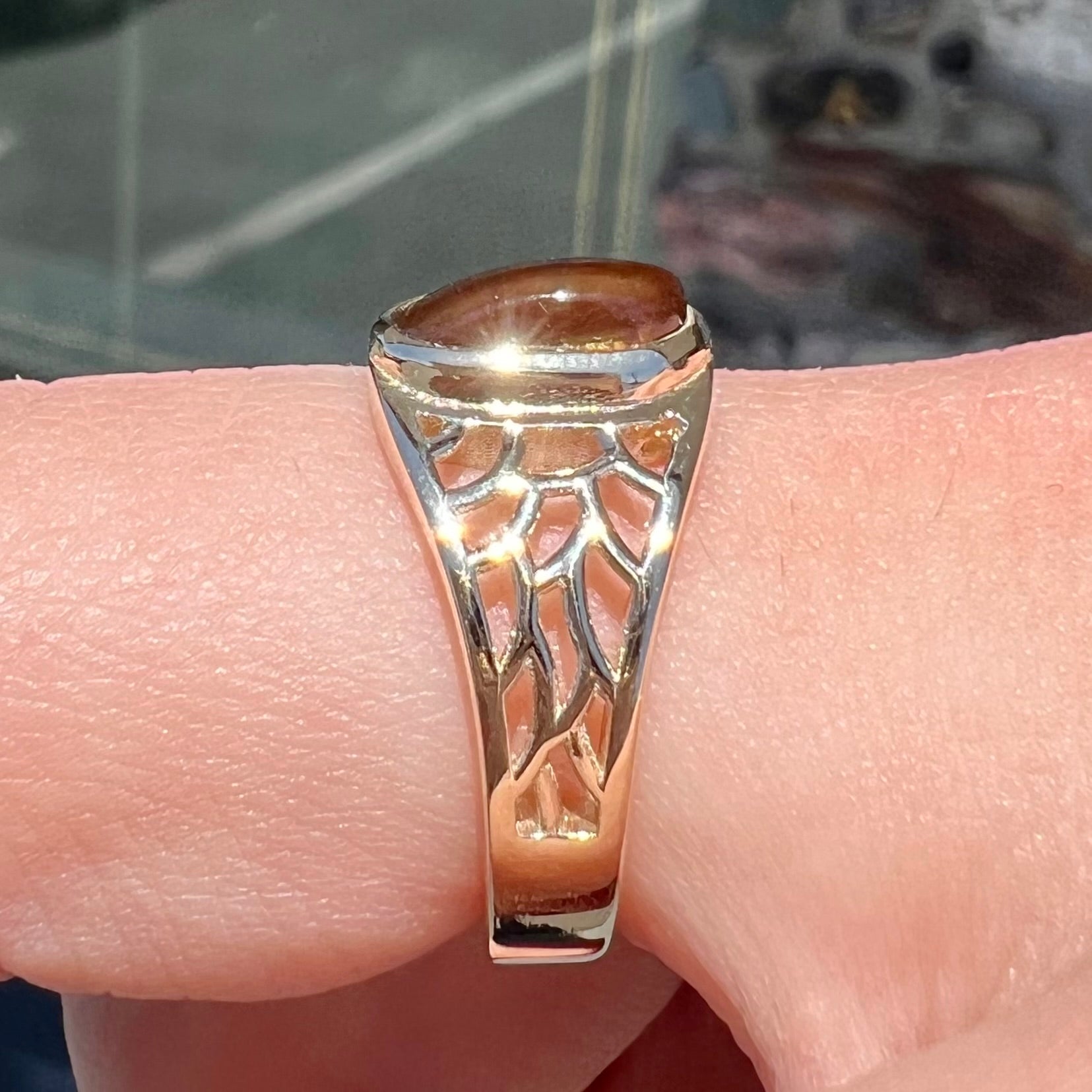 A ladies' yellow gold ring set with two fire agate stones: one green, and one red.