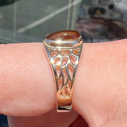 A ladies' yellow gold ring set with two fire agate stones: one green, and one red.