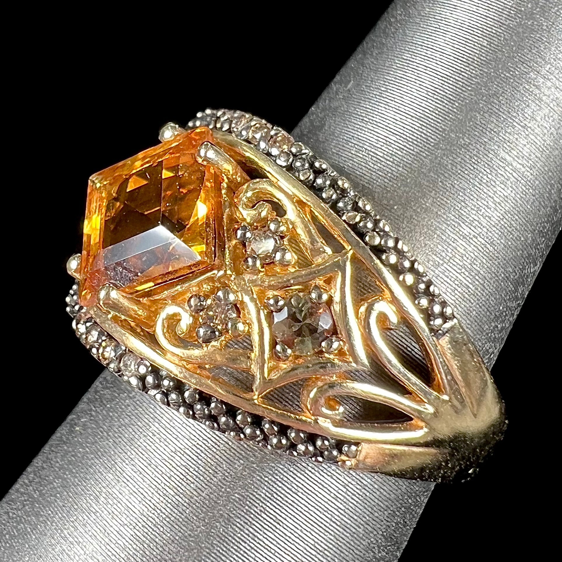 A square cut citrine and chocolate diamond filigree ring with andalusite accents.
