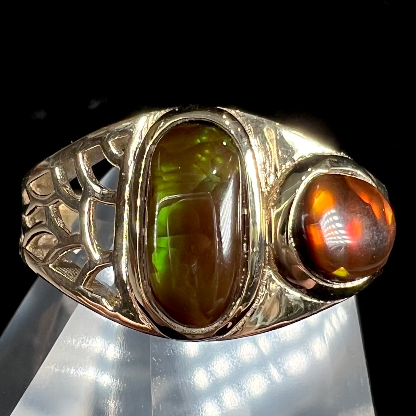 A ladies' yellow gold ring set with two fire agate stones: one green, and one red.