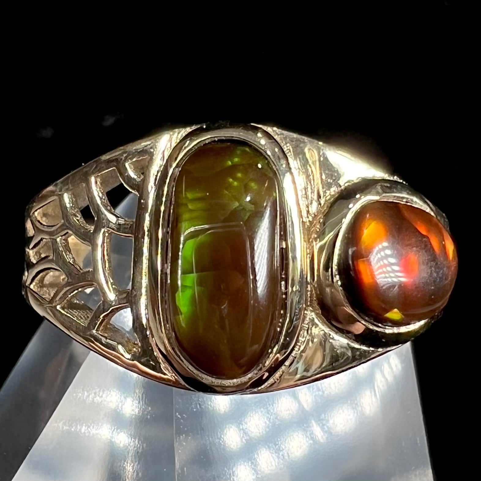 A ladies' yellow gold ring set with two fire agate stones: one green, and one red.