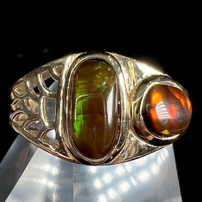 A ladies' yellow gold ring set with two fire agate stones: one green, and one red.