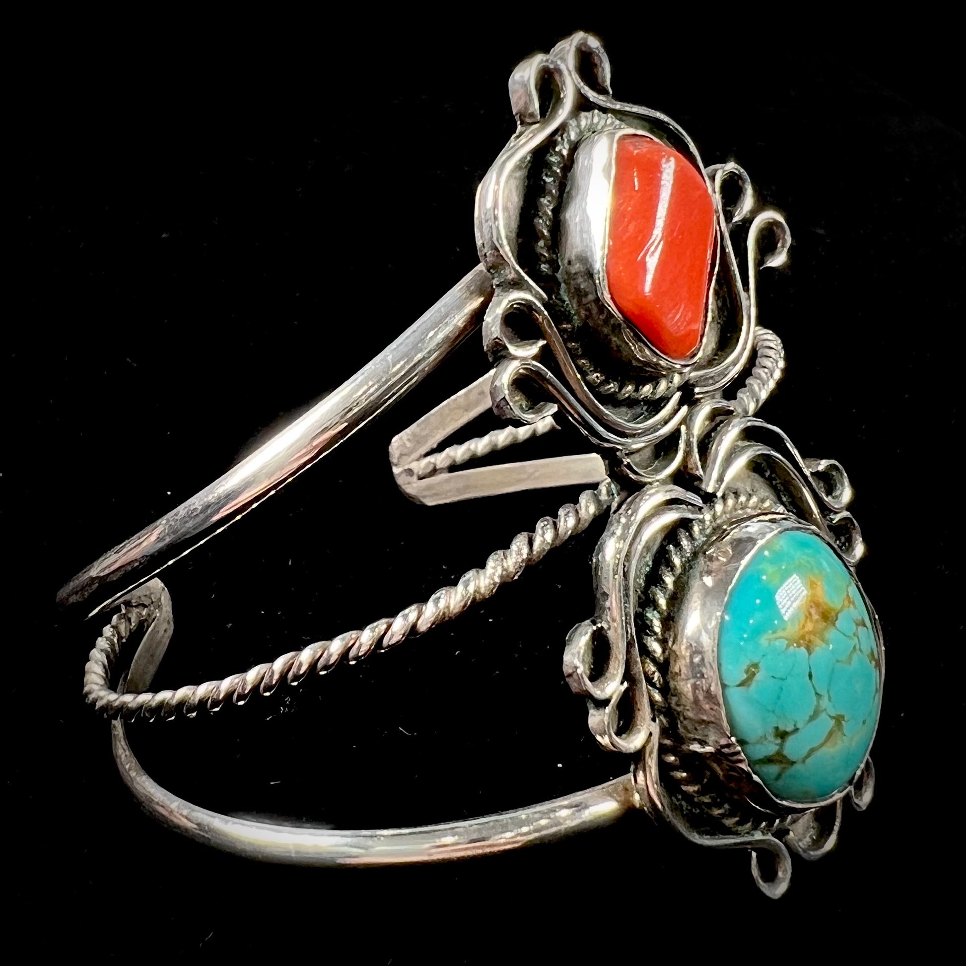 A ladies' Navajo cuff bracelet set with Royston turquoise and Mediterranean coral stones.