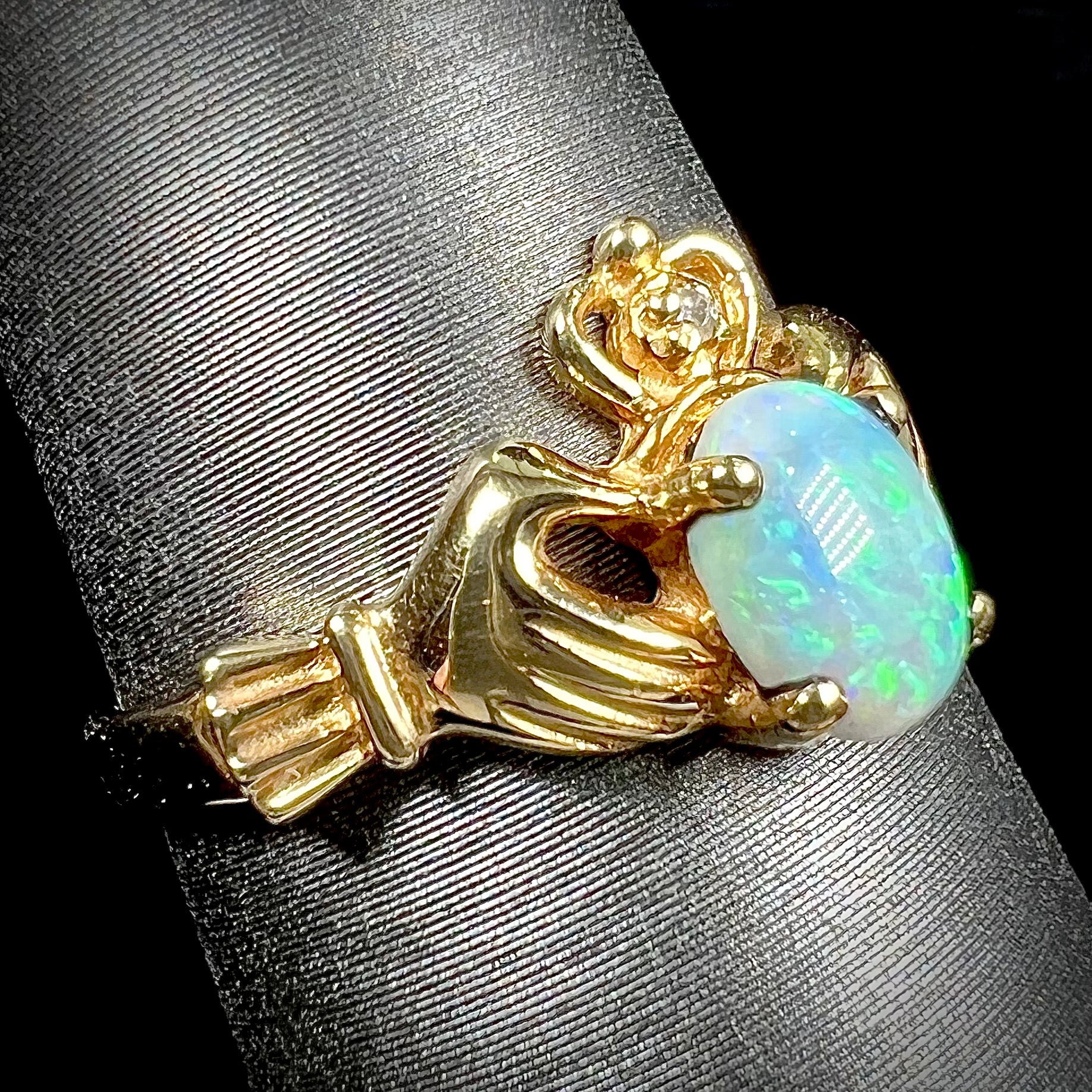A vintage ladies' yellow gold opal and diamond claddagh ring.