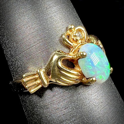 A vintage ladies' yellow gold opal and diamond claddagh ring.