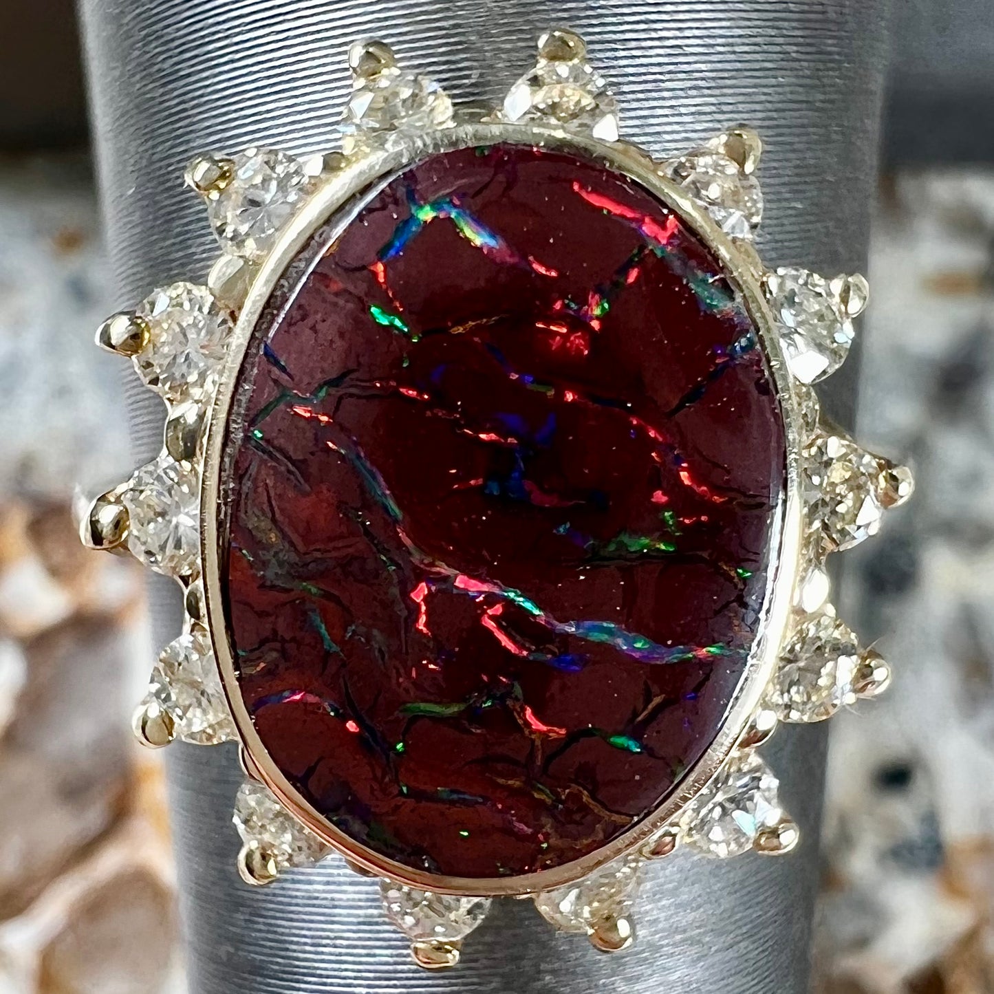 A ladies' diamond halo and Koroit boulder opal engagement ring.