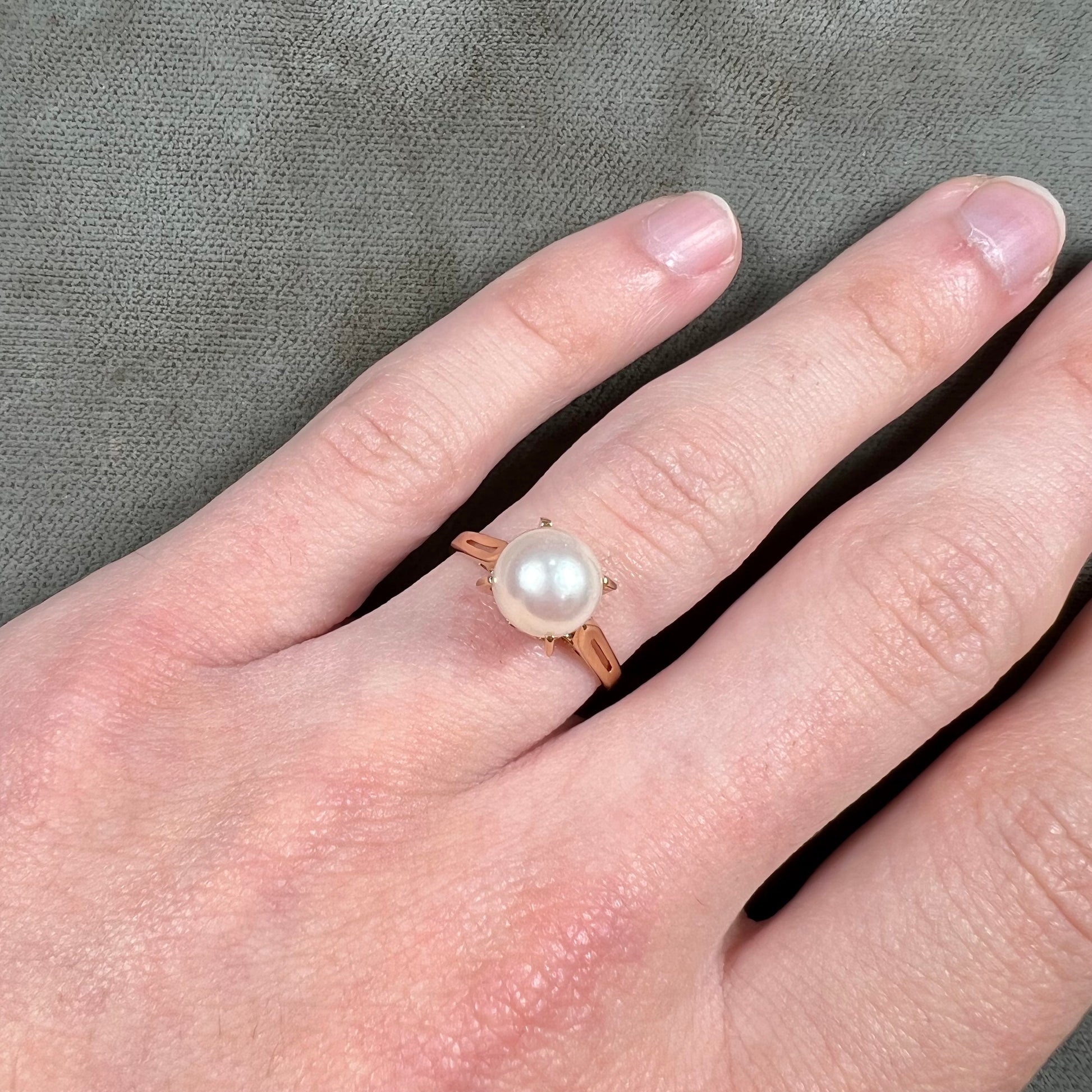 Round white pearl with pink overtones set in a vintage 18k yellow gold ring.