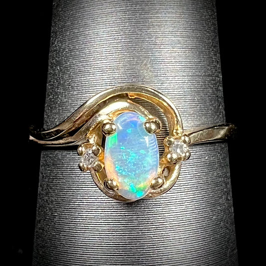 A dainty ladies' yellow gold opal and diamond accent ring.