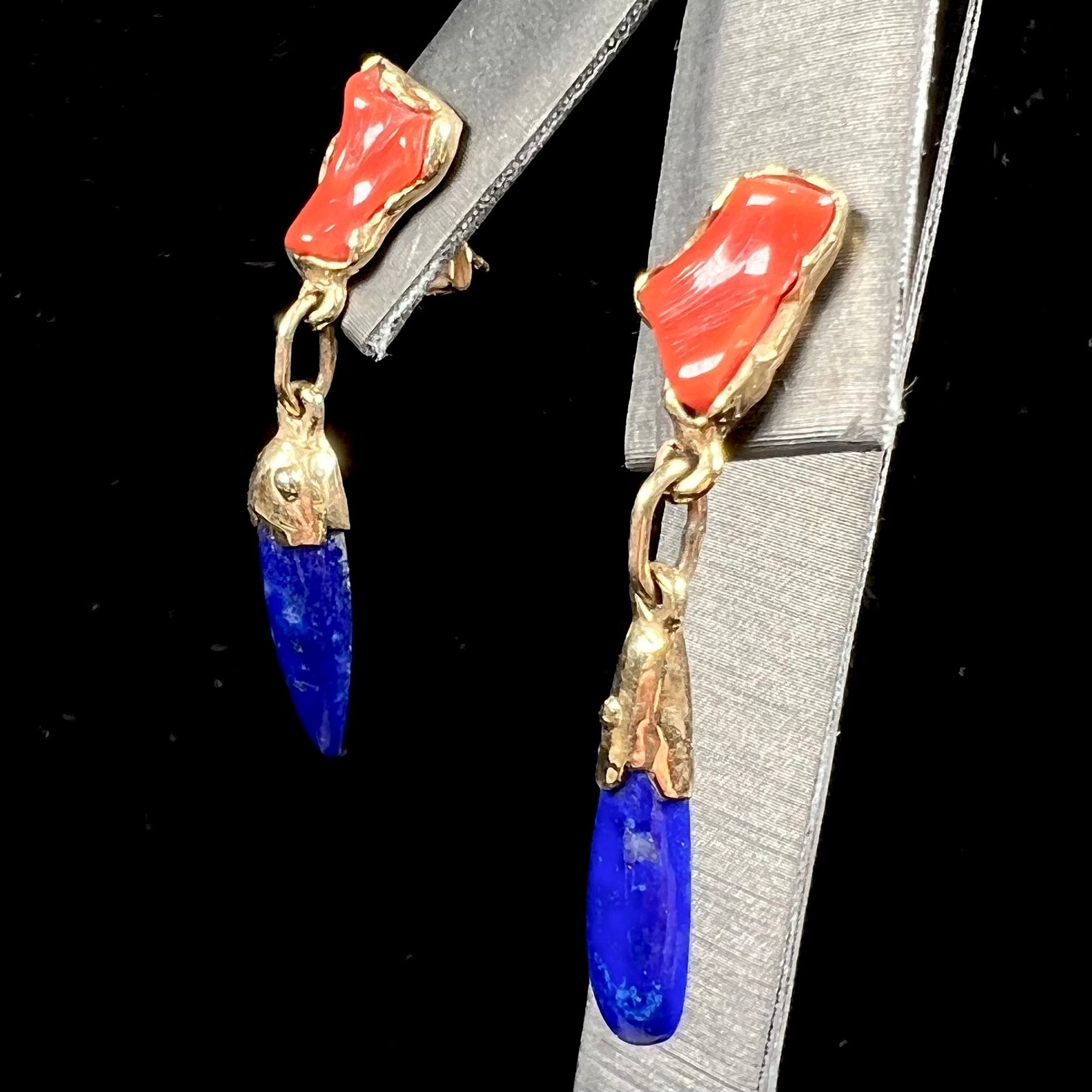 A pair of Navajo-handmade yellow gold dangle earrings set with lapis lazuli and polished coral branches.