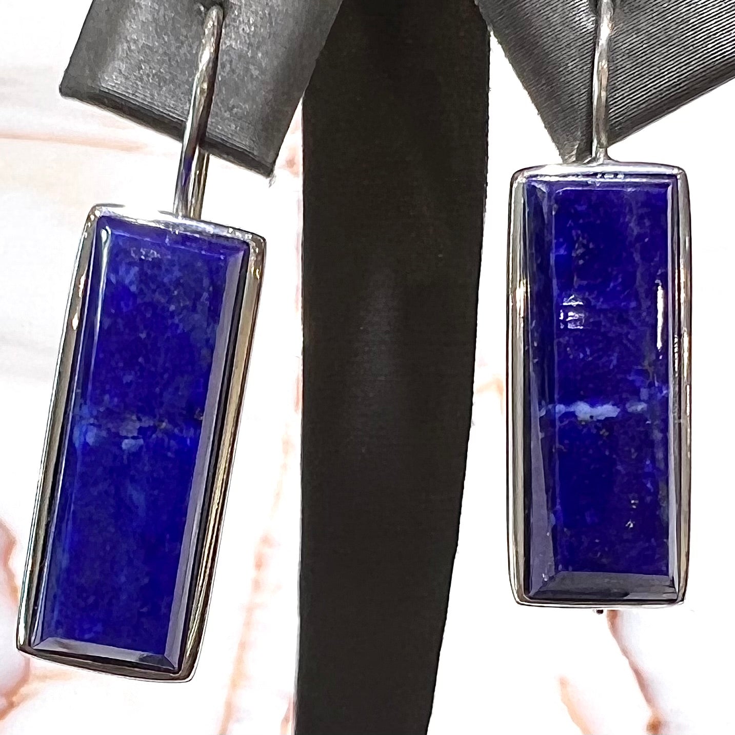 Rectangular cut lapis lazuli stones bezel set in sterling silver wire earrings.