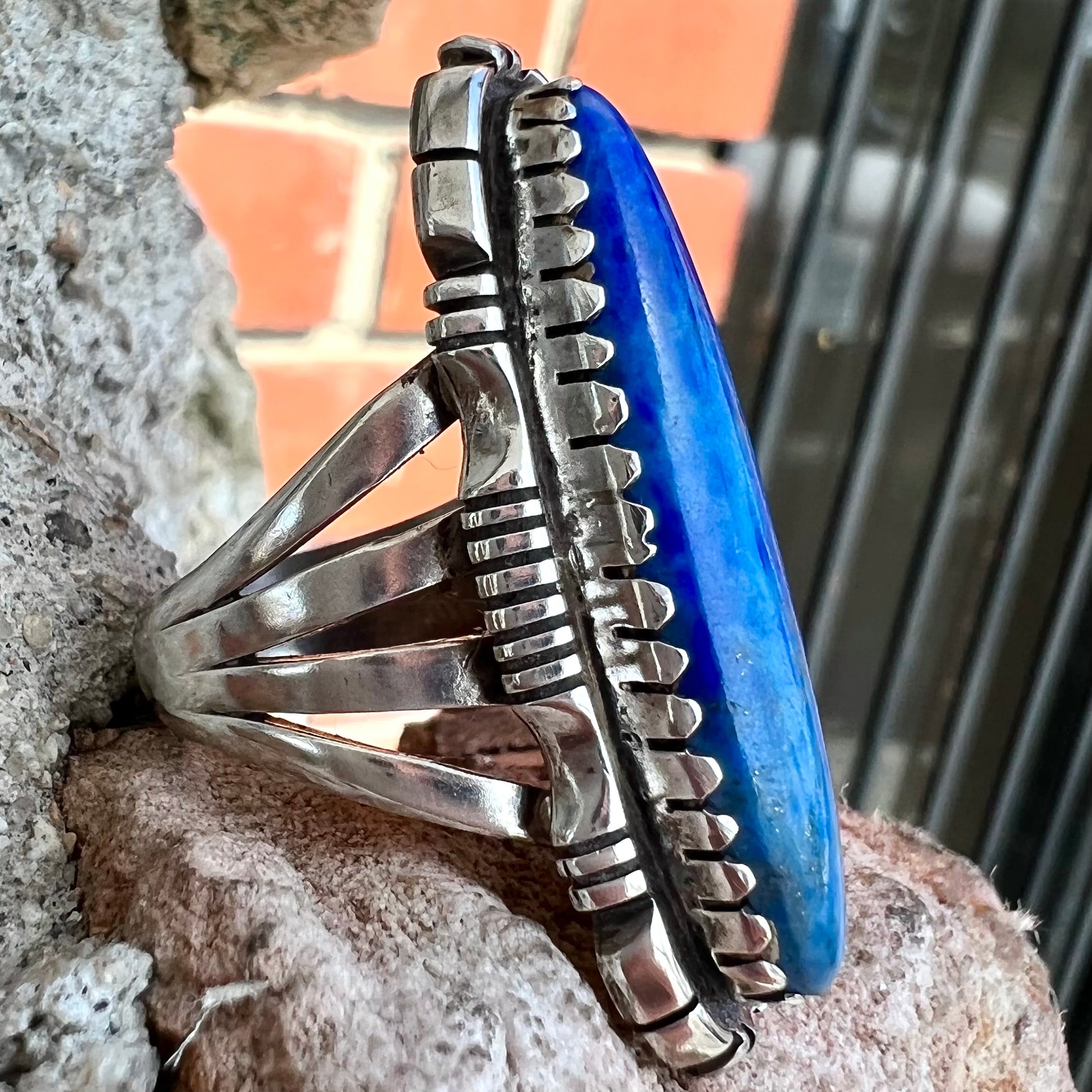 A Navajo style sterling silver lapis lazuli ring engraved with the words "R. Bennett".
