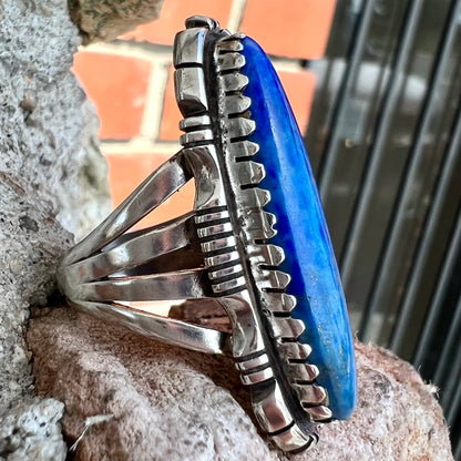 A Navajo style sterling silver lapis lazuli ring engraved with the words "R. Bennett".