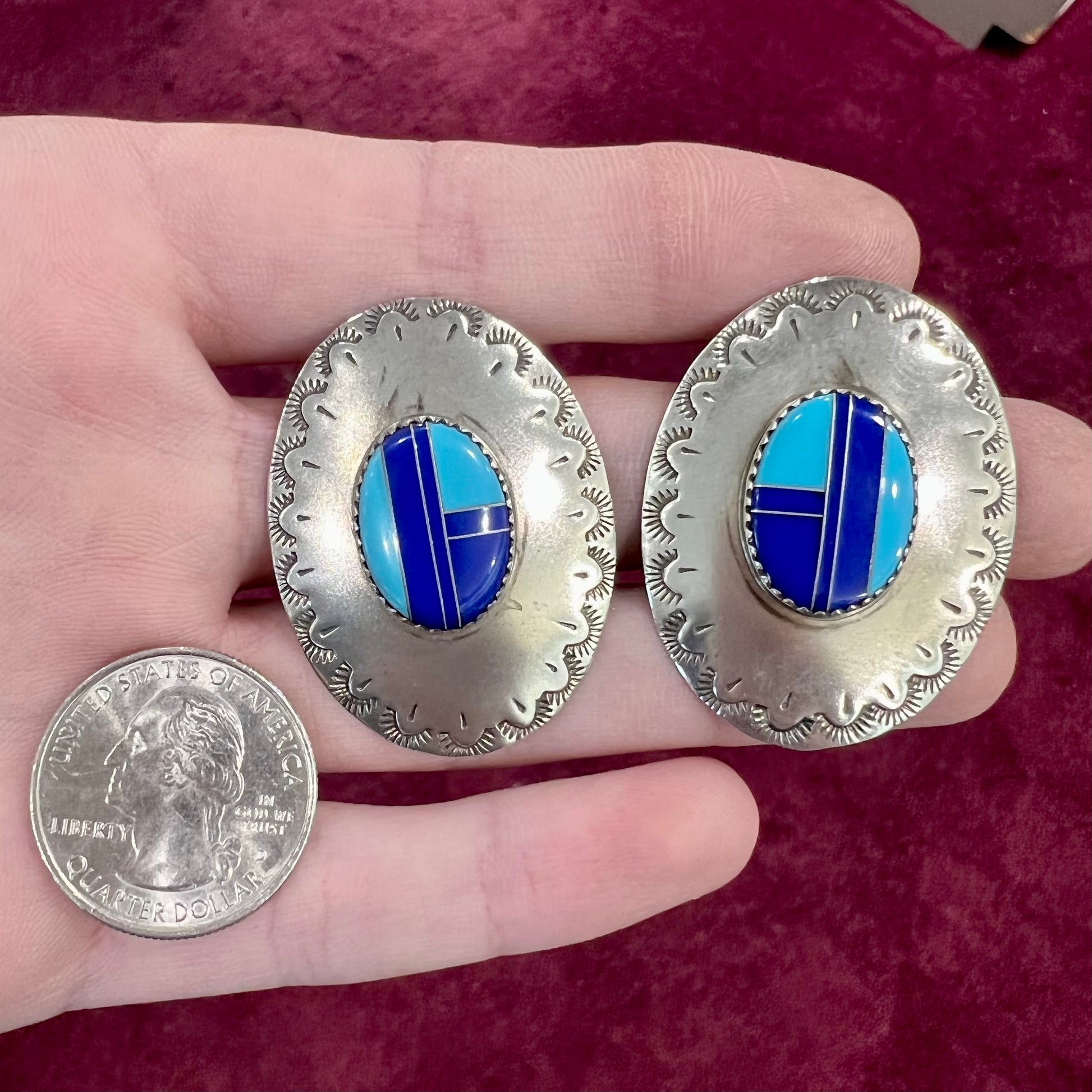 A pair of sterling silver concho earrings set with lapis lazuli and turquoise stone inlay.