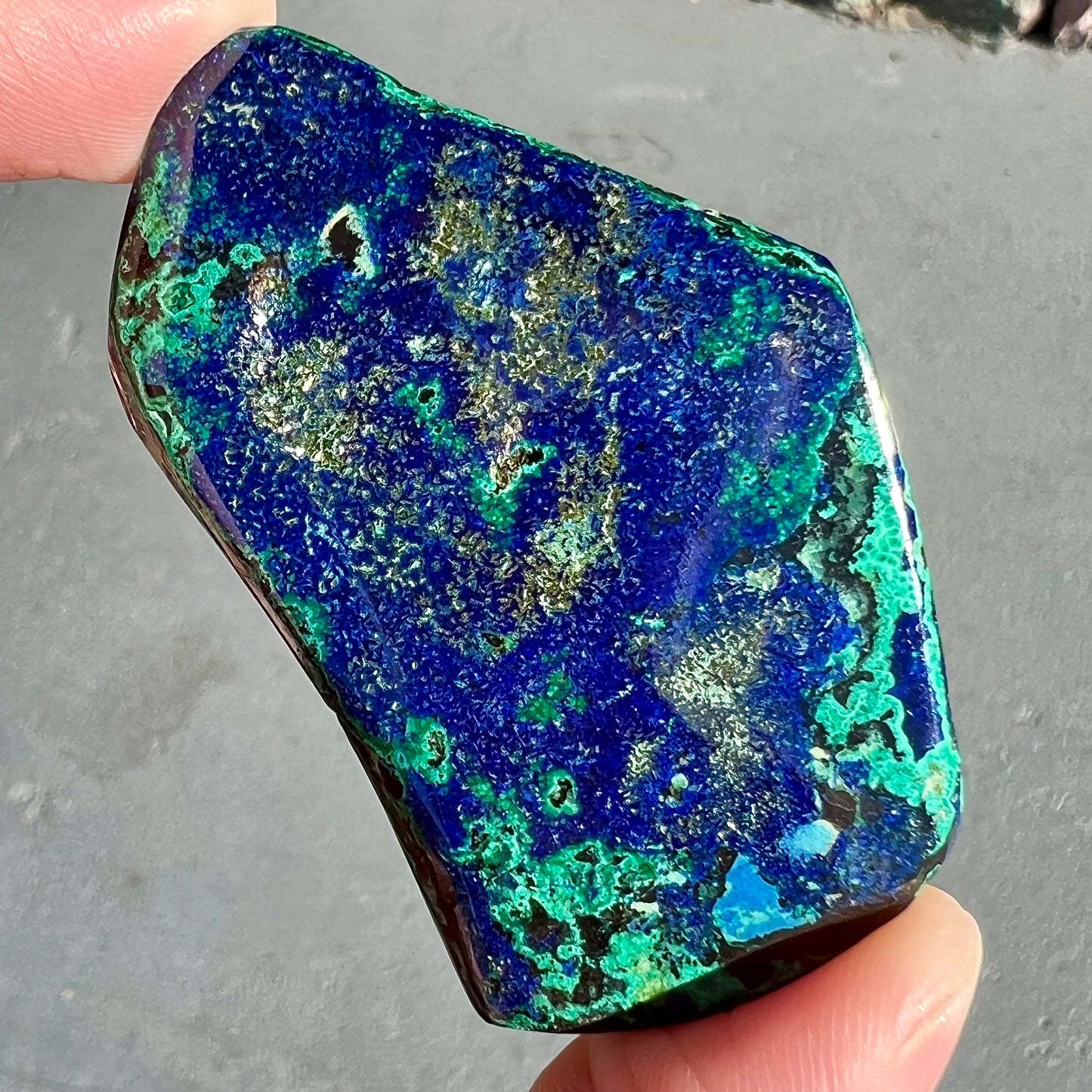 A thick polished slab of azurite with malachite inclusions.