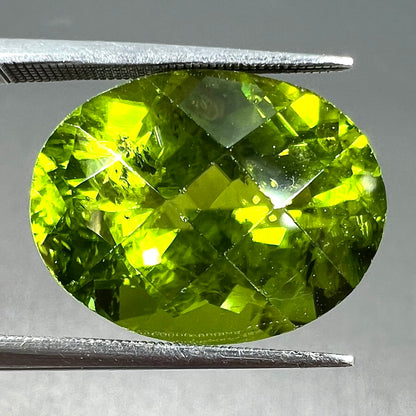 A loose, faceted oval checkerboard cut peridot gemstone from Pakistan.