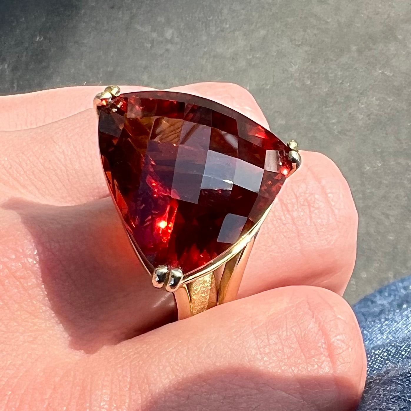 A ladies' trillion cut madeira citrine cocktail ring handmade in yellow gold.