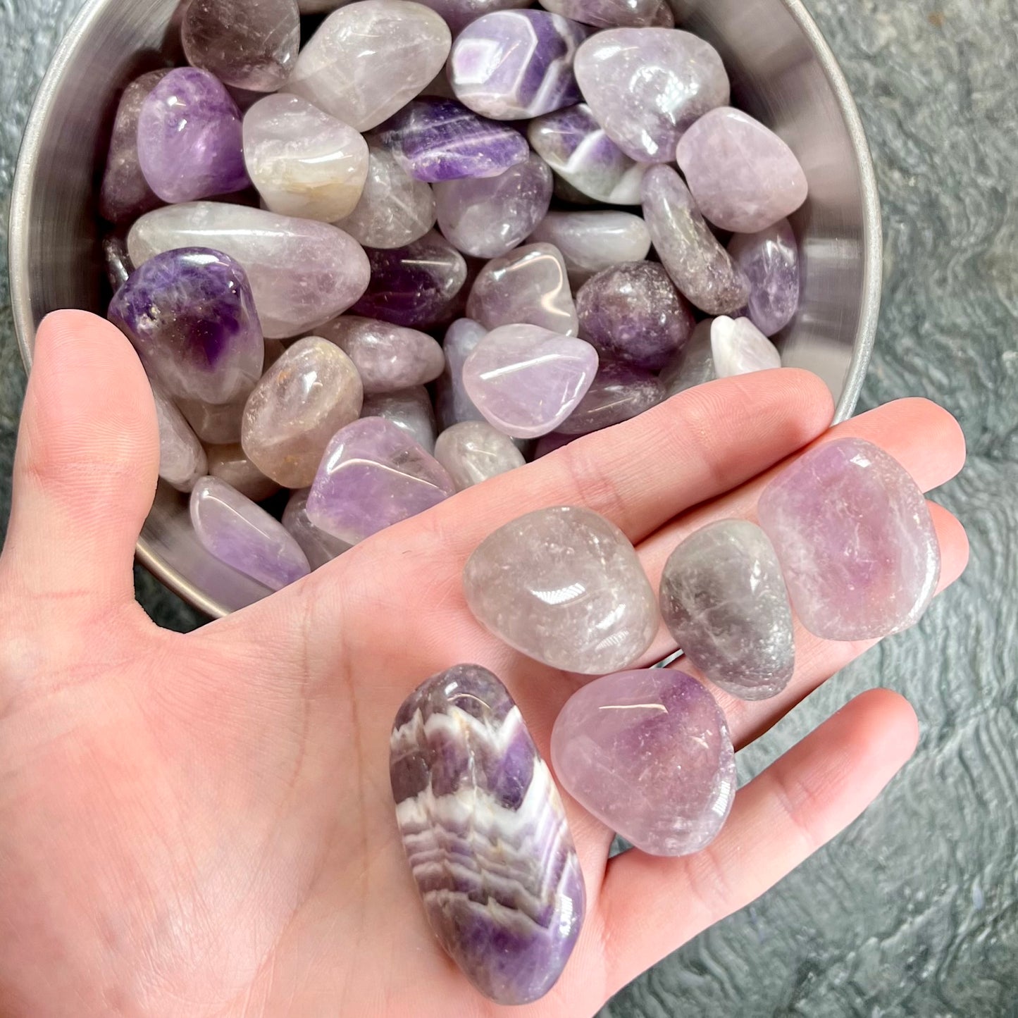 Palm sized, commercial grade, tumbled amethyst stones.