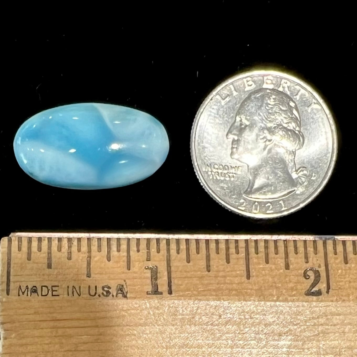 A loose, oval cabochon cut larimar stone from Dominican Republic.