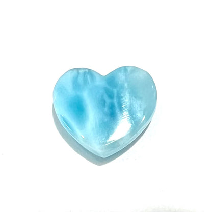 A loose, heart shaped cabochon cut larimar stone.