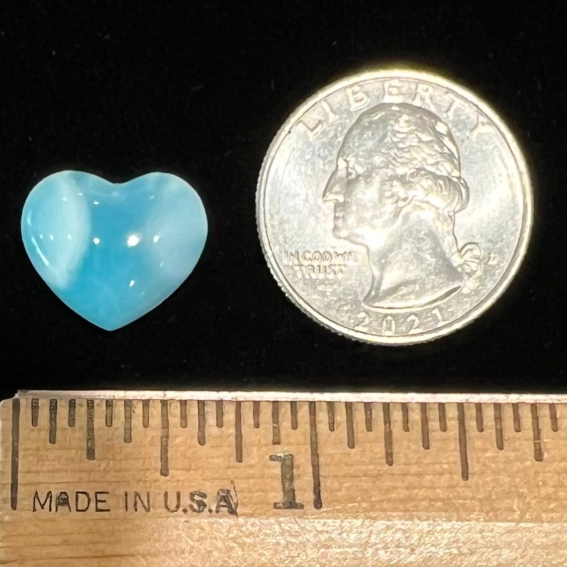 A loose, heart shaped cabochon cut larimar stone.
