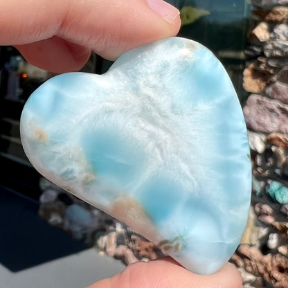 A loose, carved, heart shaped larimar stone.  Predominant colors are blue and white.