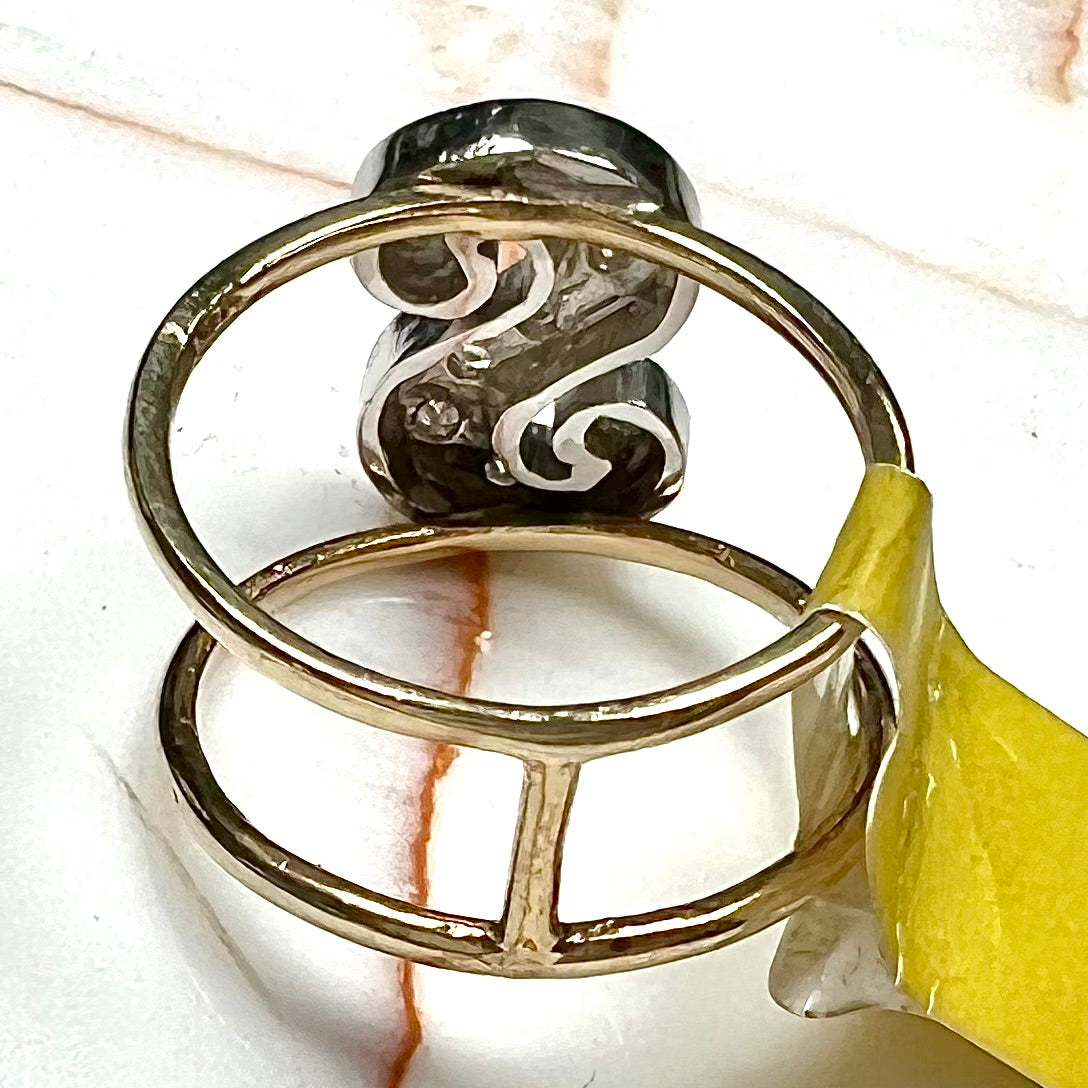 A two tone white and yellow gold initial ring of the letter "S" set with diamonds.