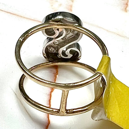 A two tone white and yellow gold initial ring of the letter "S" set with diamonds.