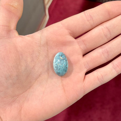 A loose, oval cabochon cut turquoise stone from Baja California.