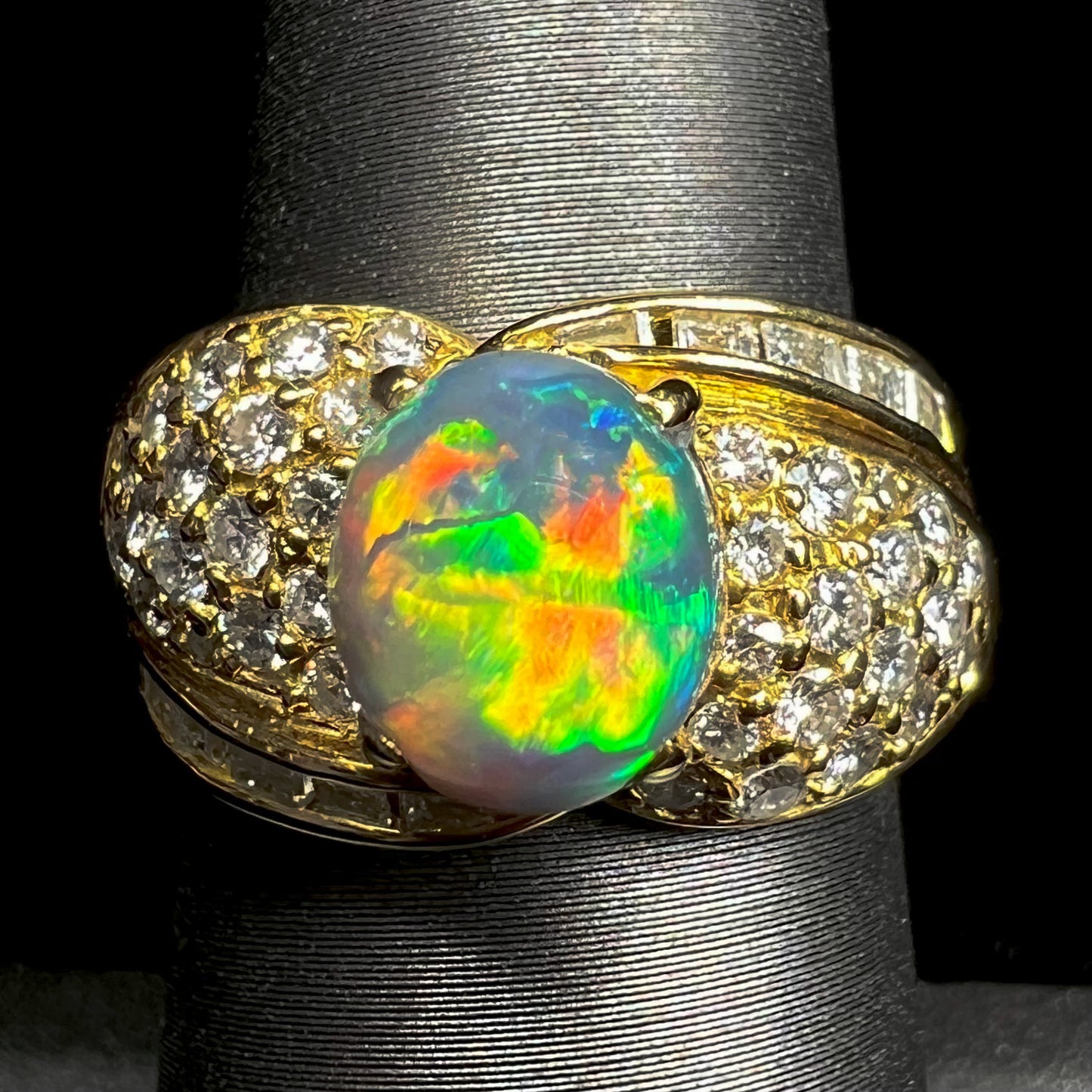 A natural, Australian black opal and diamond ring cast in 18 karat yellow gold..