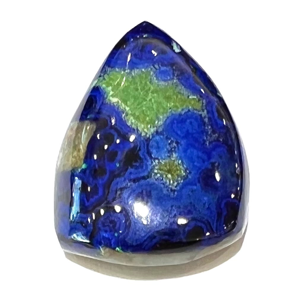 A loose pear shape cabochon cut blue azurite stone with green pseudomalachite inclusions.