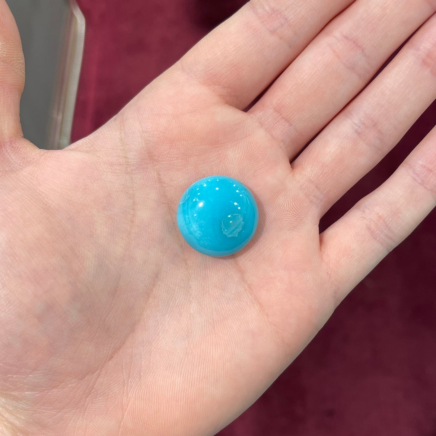 A loose, round cabochon cut turquoise stone from Sleeping Beauty Mine, Arizona.