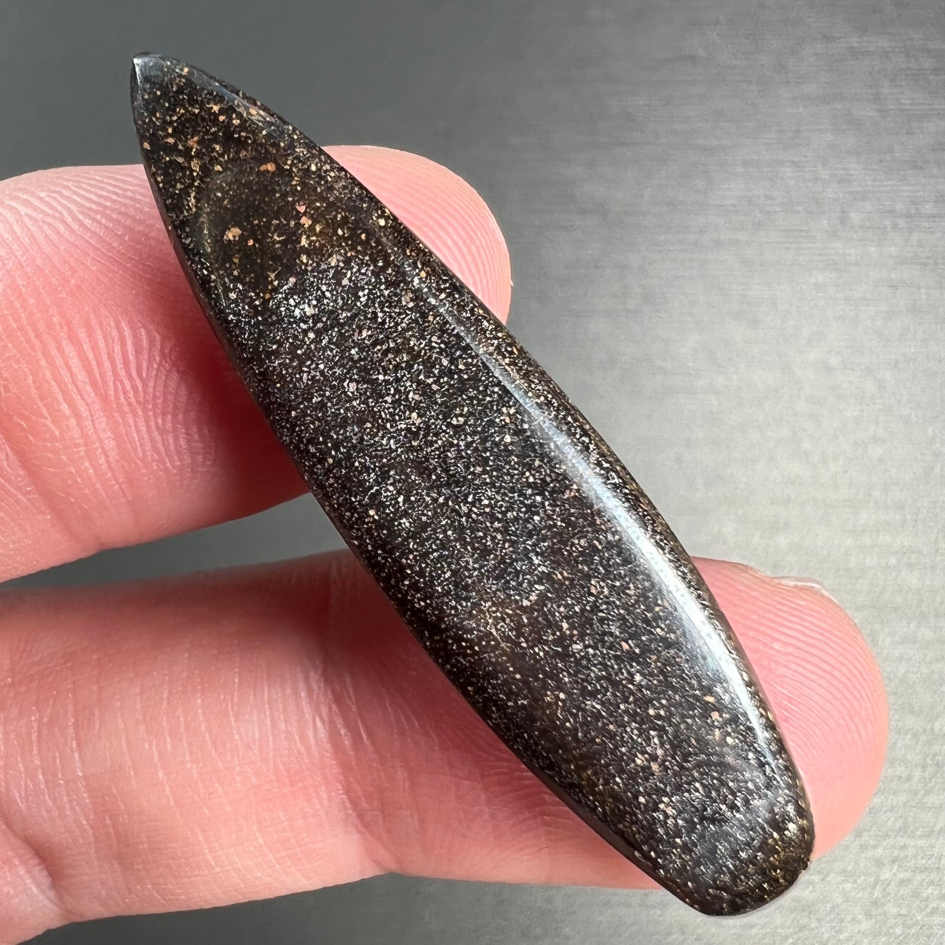 A loose, polished, point shape Quilpie boulder opal stone from Queensland, Australia.