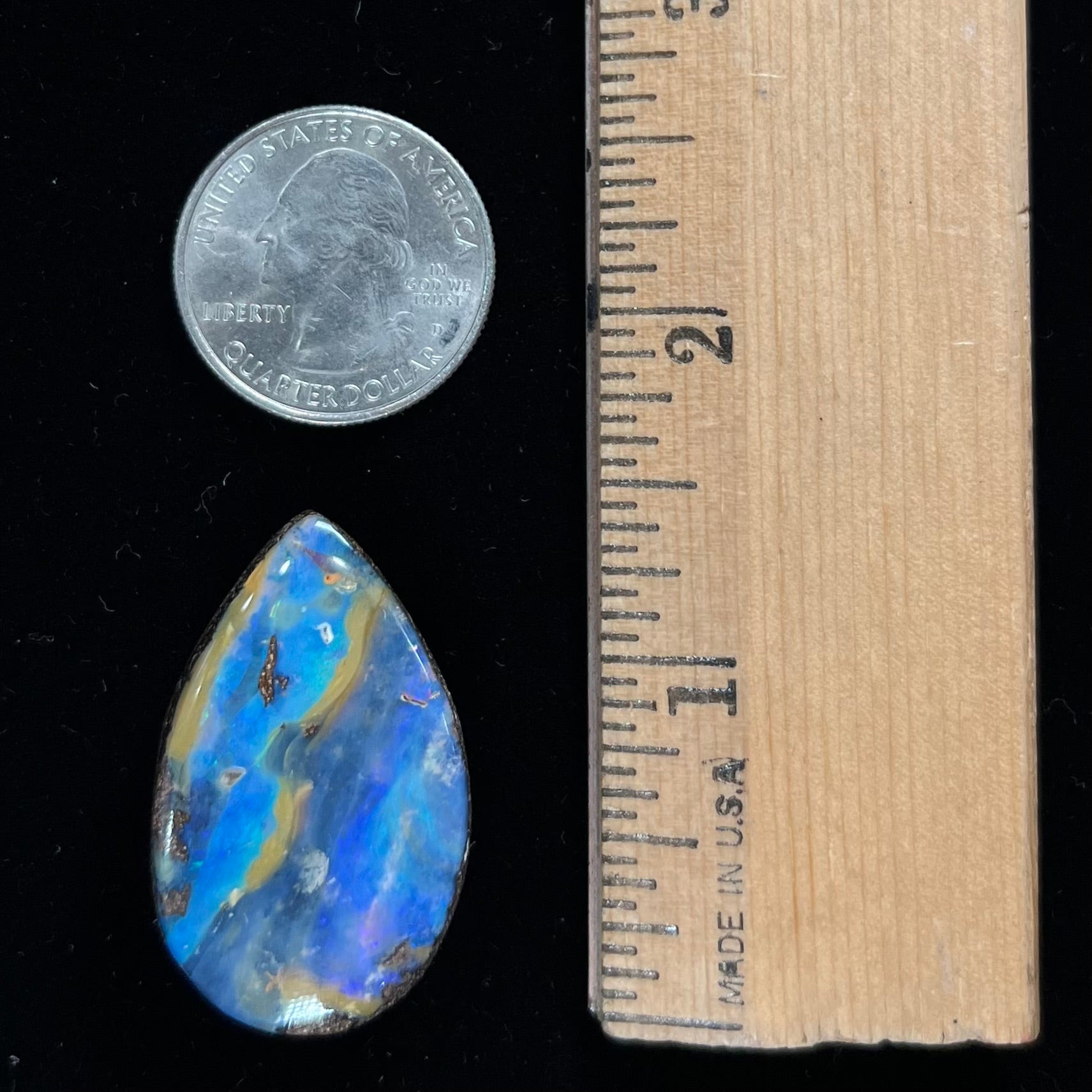 A loose, pear shaped cabochon cut boulder opal stone from Quilpie, Australia.