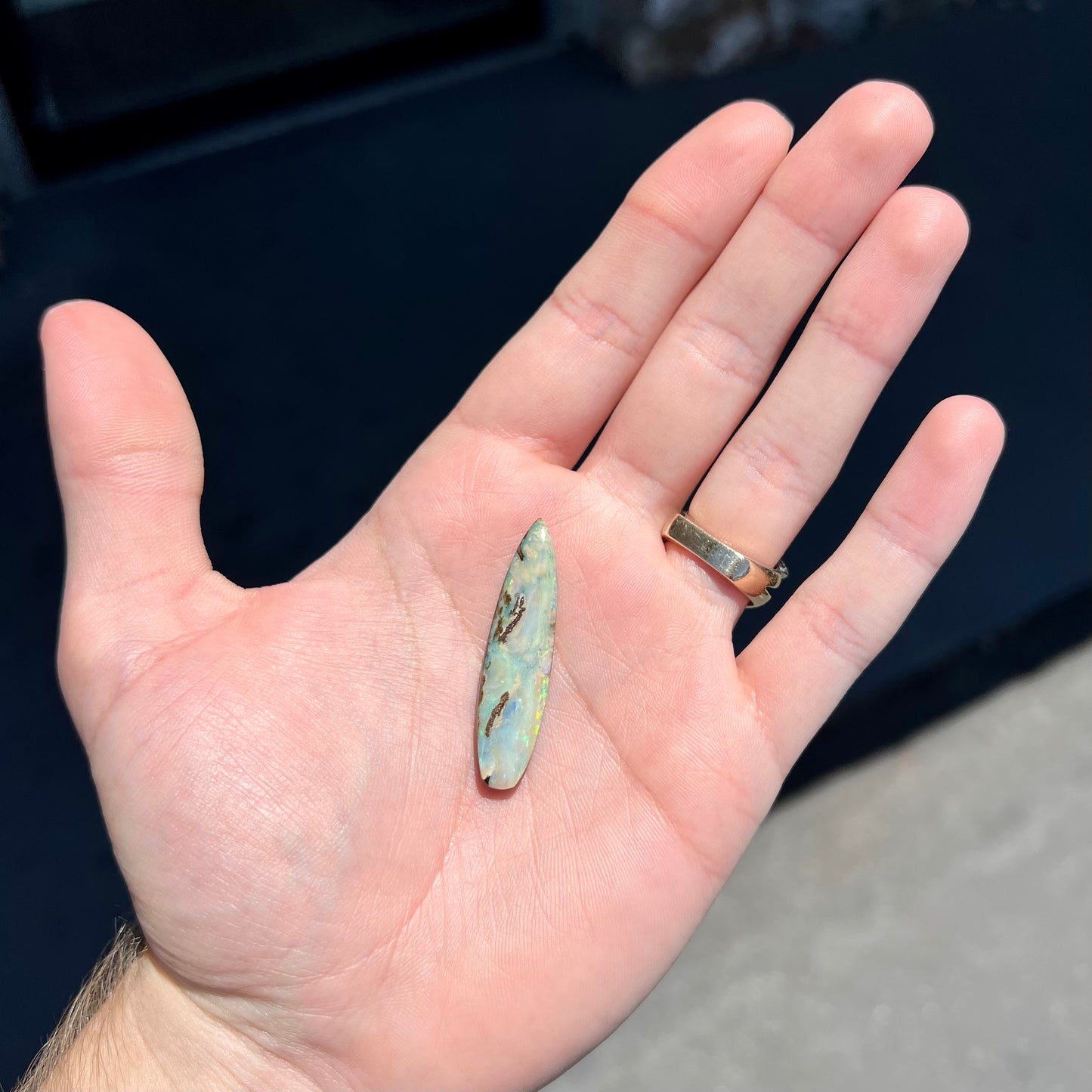 A loose, polished, point shape Quilpie boulder opal stone from Queensland, Australia.