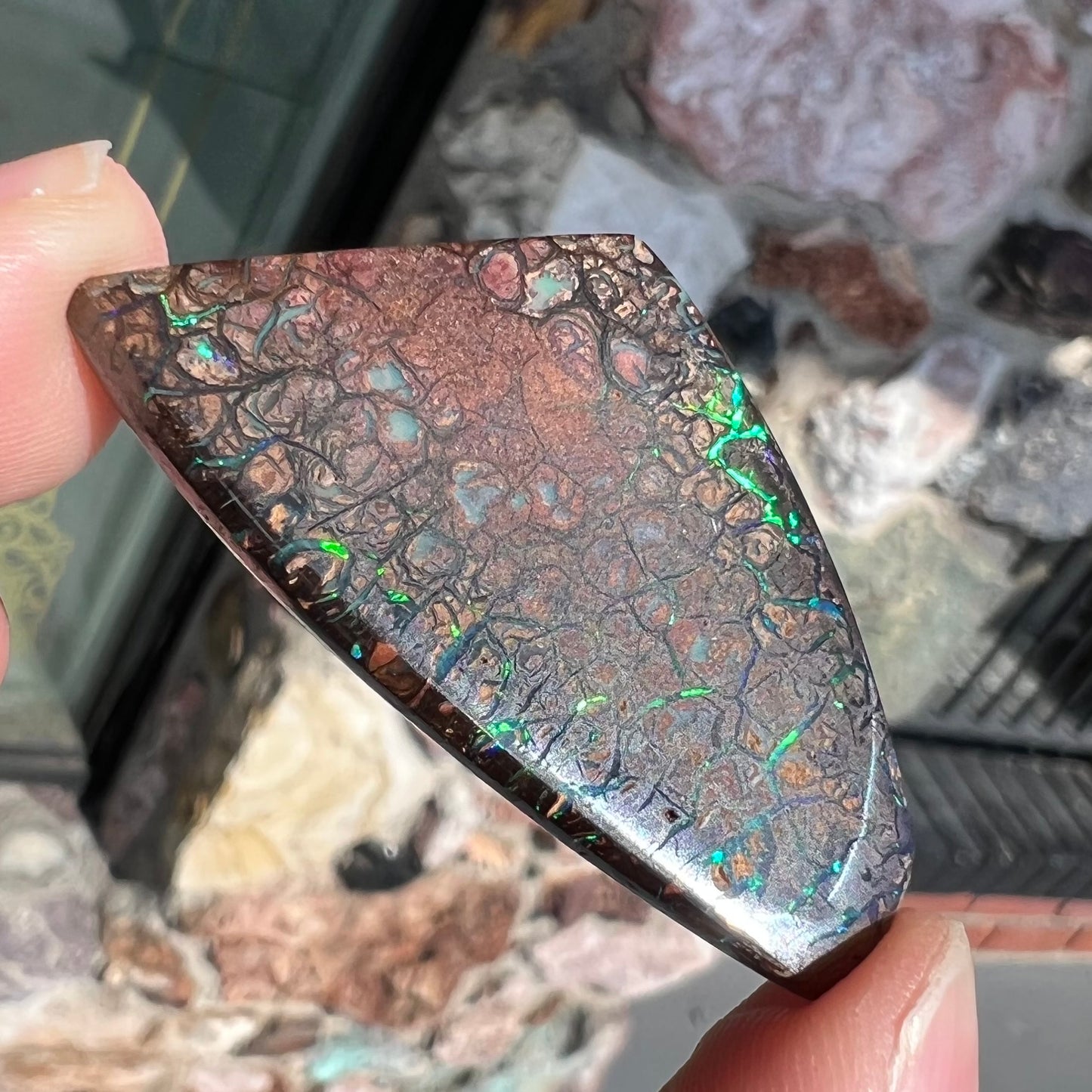 A loose, patterned boulder opal stone from the Koroit Mining District in Queensland, Australia.