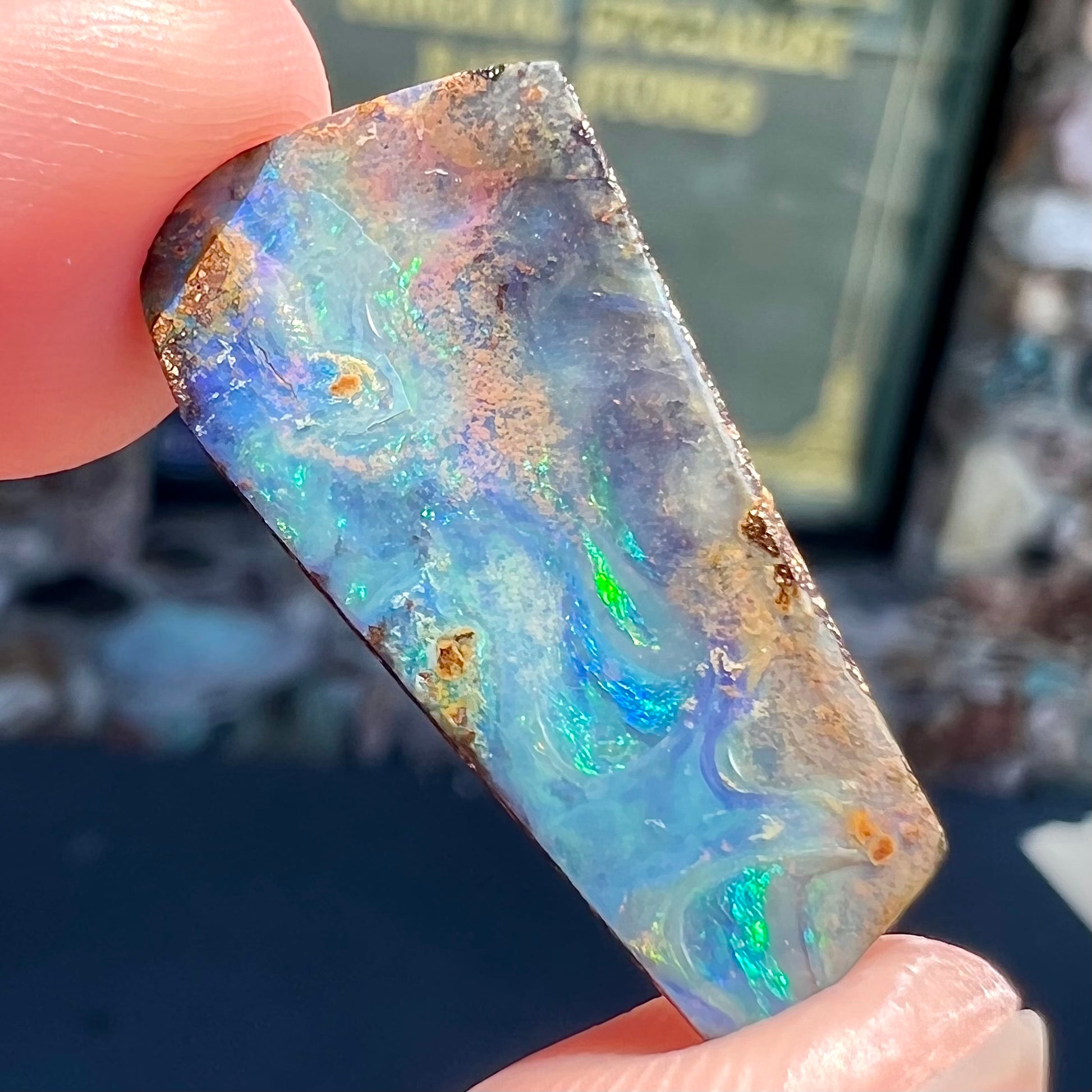 A loose, freeform cut boulder opal stone from Quilpie, Australia.