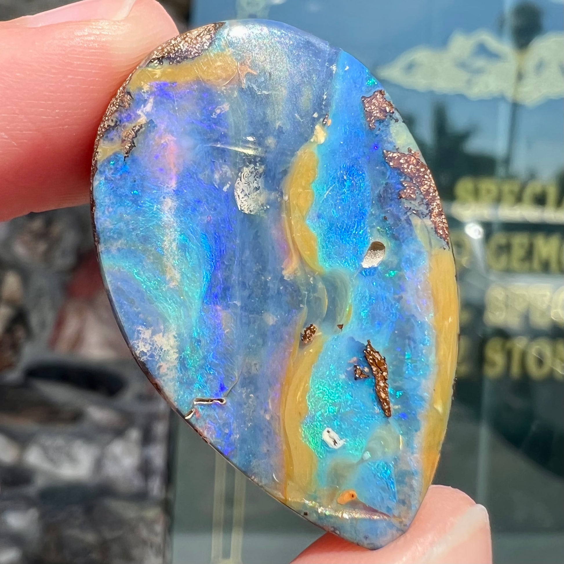 A loose, pear shaped cabochon cut boulder opal stone from Quilpie, Australia.