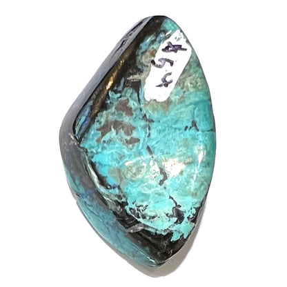 A loose chrysocolla stone with turquoise inclusions.