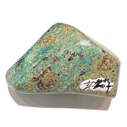 A loose polished chrysocolla stone with malachite inclusions.