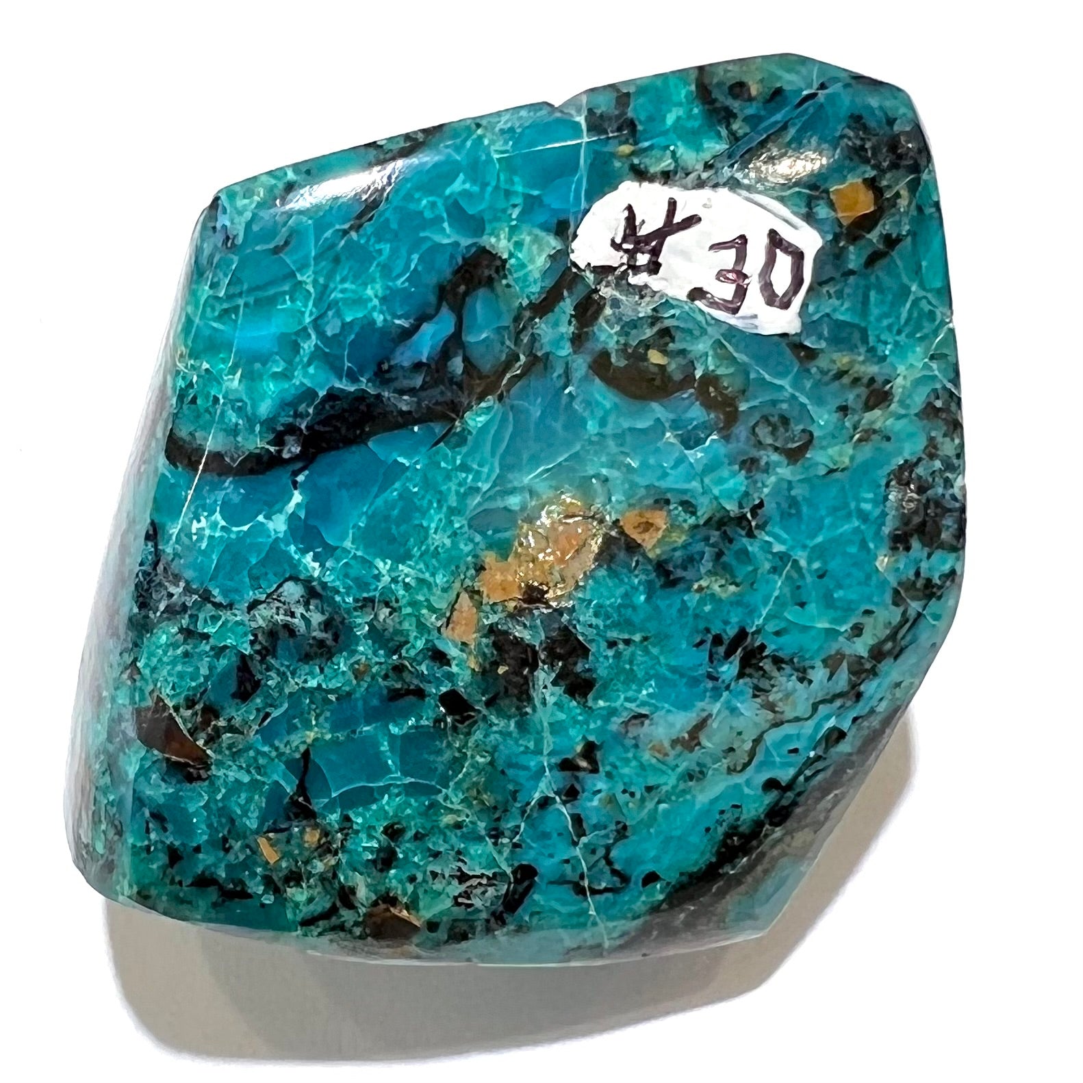 A loose polished chrysocolla specimen that has a crackled effect.