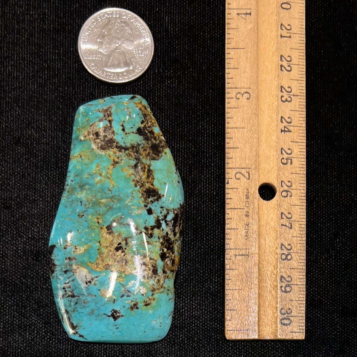 Loose turquoise stone from Cow Springs, Nevada.  Black and white matrix is visible.